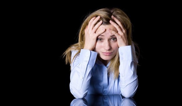 depression, headache, attractive blond female isolated on black